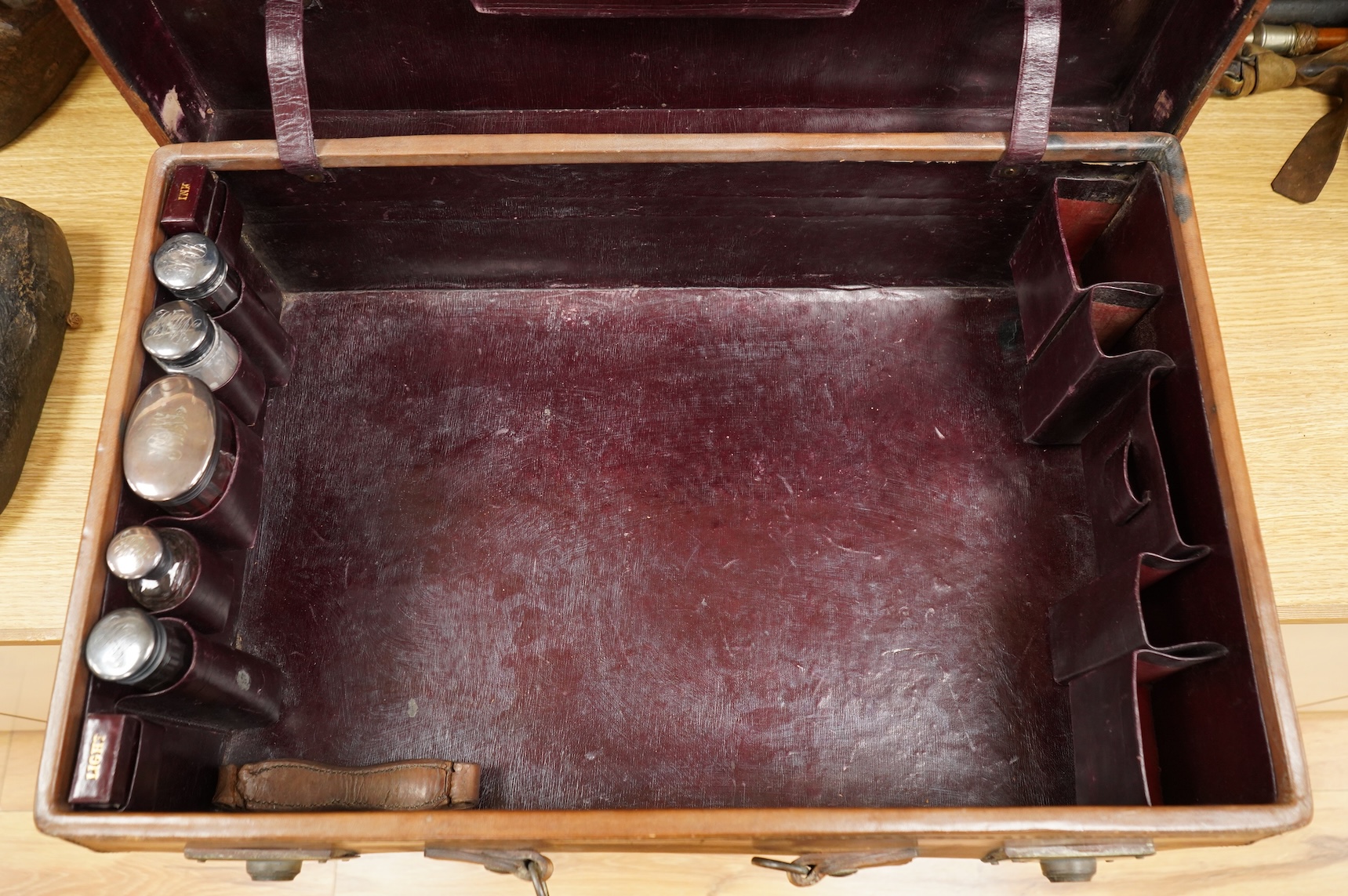 A leather toilet case with silver mounted contents, 61cm wide